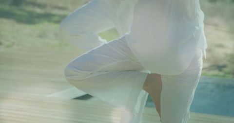 Couple in Matching Outfits Practicing Yoga on Deck