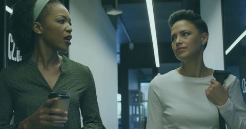 Walking colleagues engaged in hallway conversation