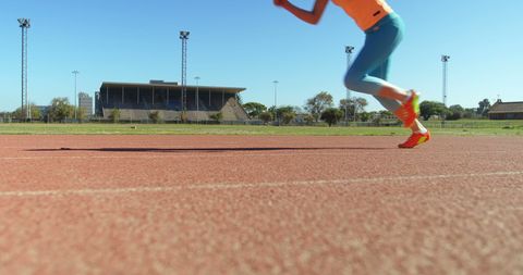 Caucasian Female Athlete Running on Outdoor Track at Sports Venue - Download Free Stock Images Pikwizard.com
