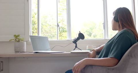 Podcasting In Home Office With Laptop And Microphone