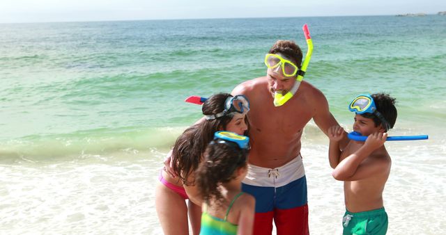 Family wearing snorkel gear enjoying a playful moment on a sunny beach. Suitable for concepts like vacation, summer fun, outdoor activities, family bonding, travel, and tropical holidays. Perfect for advertisements promoting beach resorts, family vacations, snorkel gear, and travel packages.