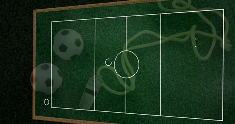 Soccer coaching tactics board on turf with balls whistle markers and training plan