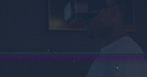 Man engaged in virtual reality immersion in dark environment