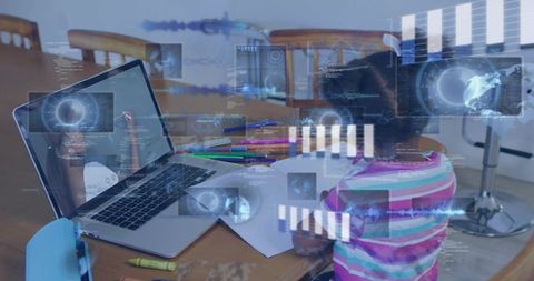 Child doing homework with laptop and augmented reality learning overlays at dining table