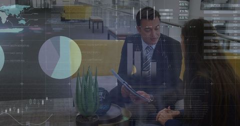 Diverse business partners analyzing digital statistics in modern office