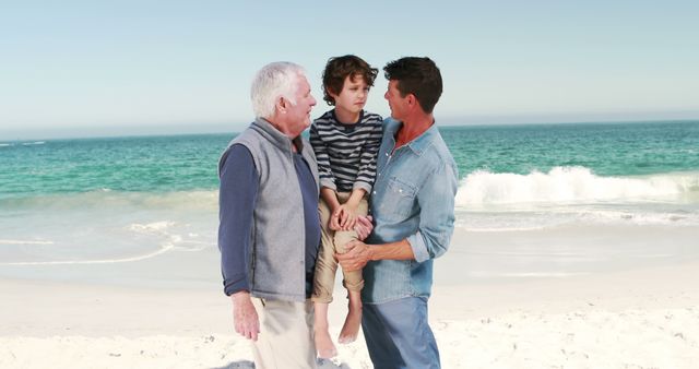 Young boy with his father and grandfather on the beach