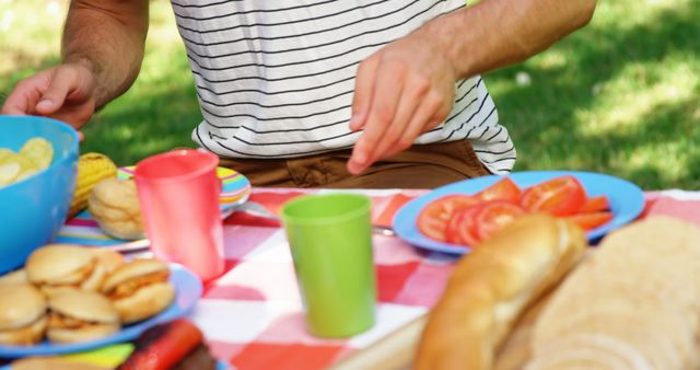 Person Enjoying Picnic with Snacks and Juices Outdoors - Download Free Stock Images Pikwizard.com