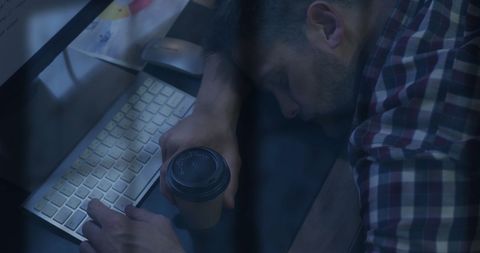 Exhausted businessman sleeping at desk with rainy ambiance