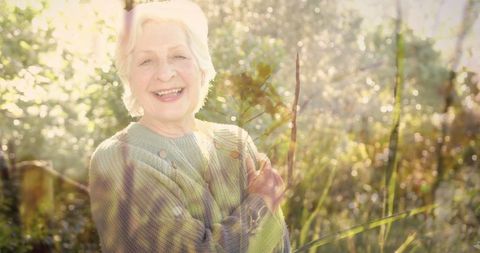 Happy Senior Woman Enjoying Nature in Bright Garden