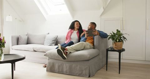 Excited couple celebrating pregnancy at home together