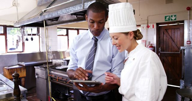 Restaurant Manager Discussing Menu with Chef - Download Free Stock Images Pikwizard.com