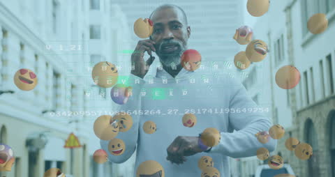 Man Engaging with Smartphone Surrounded by Digital Emojis