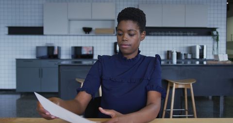 Focused African American Businesswoman Engaged in Paperwork