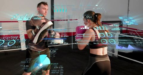 Female boxer training with coach mitts in ring with augmented reality performance hud