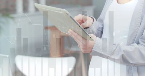 Businesswoman Using Tablet with Overlay of Financial Graphs - Download Free Stock Images Pikwizard.com