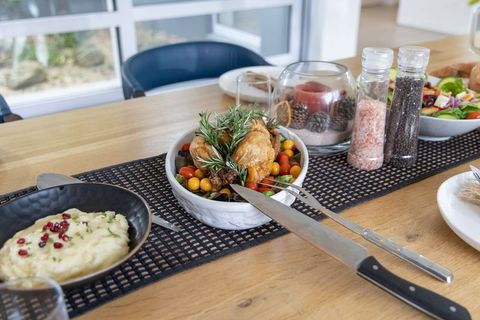 Rustic roasted chicken centerpiece with cherry tomatoes and rosemary for cozy dinner
