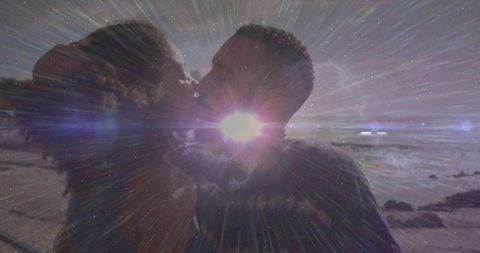 Silhouetted Couple Sharing Romantic Beach Kiss at Sunset