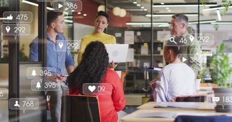 Diverse Team Engaging with Social Media Analytics in Modern Office