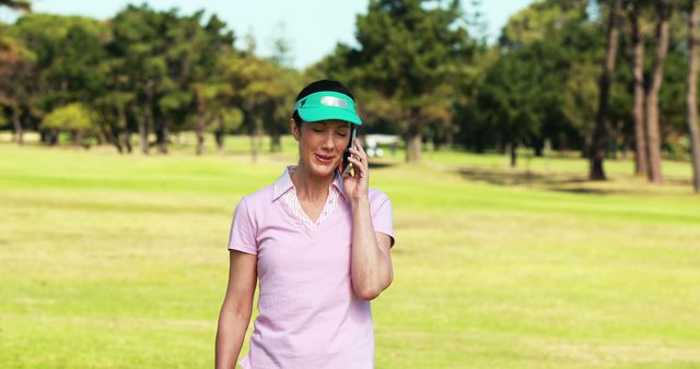 Woman Talking on Phone While Walking in Park on Sunny Day - Download Free Stock Images Pikwizard.com