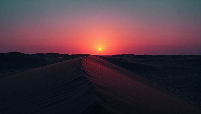 Serene Sunset Over Desert Dunes with Rippled Sand