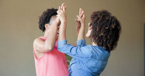 Joyful Lesbian Couple Dancing in Happiness