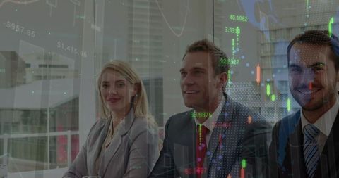 Business team analyzing financial market data in modern office