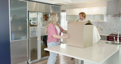 Joyful Couple Arranges New Home Interior with Boxes