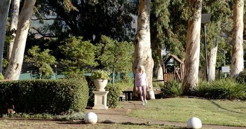 Senior Woman Enjoying Walk in Scenic Park Setting
