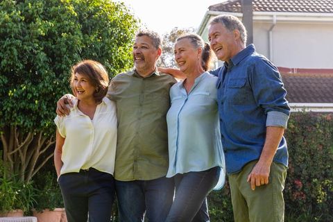 Senior Friends Enjoying Leisure Time in Sunny Backyard