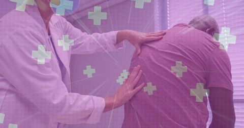 Doctor checking back pain in senior patient with medical symbols