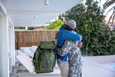 Father and Son Reunite in Warm Embrace on Patio