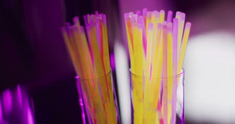 Vibrant Neon Glow Sticks in Glasses Creating Radial Effect