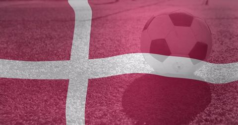 Football on Field Overlayed with Denmark Flag