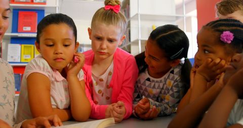 Engaged Schoolchildren Learning with Teacher in Library - Download Free Stock Images Pikwizard.com