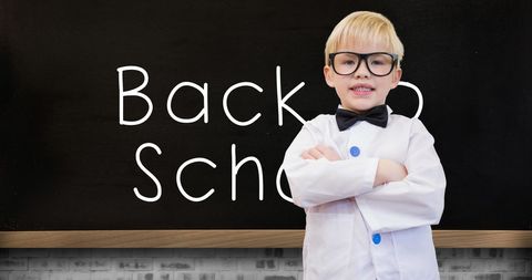 Confident Schoolboy in Glasses Standing in Front of Blackboard - Download Free Stock Images Pikwizard.com