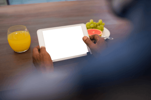 Man Engaged with Tablet Displaying Transparent Tablet Screen Concept