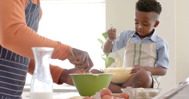 African American Grandfather and Grandson Preparing Muffin Batter Together in Kitchen - Download Free Stock Images Pikwizard.com