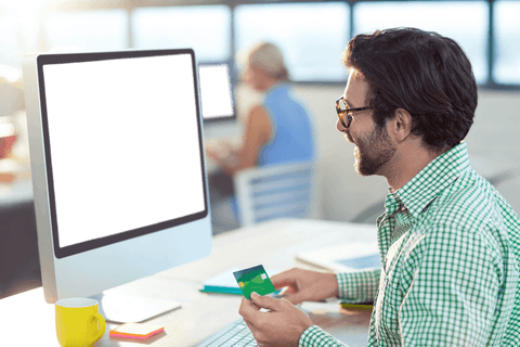 graphic designer holding credit card with transparent computer screen - Download Free Stock Videos Pikwizard.com