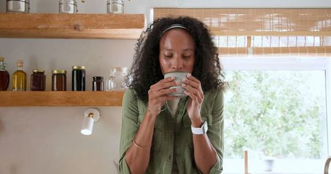 Woman Sipping Coffee in Cozy Kitchen with Rustic Decor