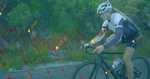 Female cyclist with timing graphics on scenic roadway