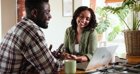 Friends sharing moments with smartphone at cozy home