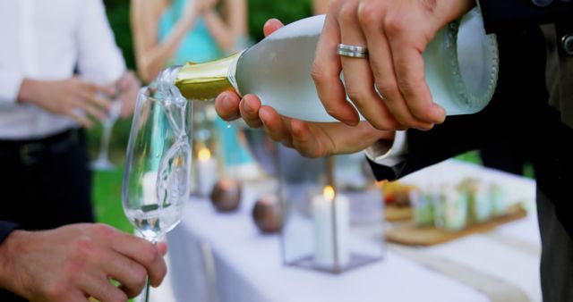 Man Pouring Champagne at Outdoor Celebration - Download Free Stock Images Pikwizard.com