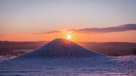 Sun Rising Over Snow Knoll Revealing Pastel Dawn Over Distant Hills Timelapse