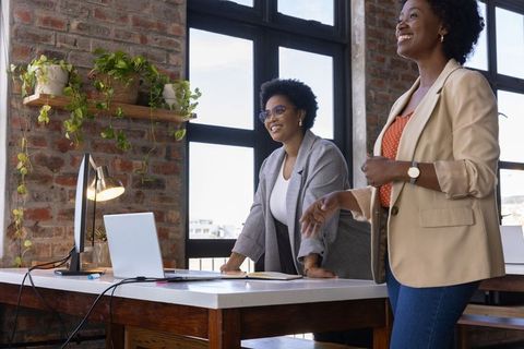 Diverse female professionals collaborating in modern office space