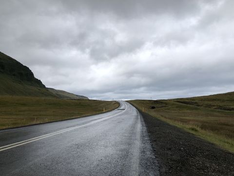 Scenic Overcast Road Leading Through Calm Countryside Landscape