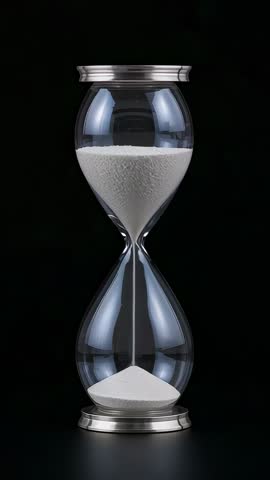 Vertical 9:16 Hourglass Video Showing White Sand Flowing Through Glass Timer