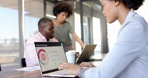 Diverse Team Analyzing Budget Chart in Modern Office Collaboration