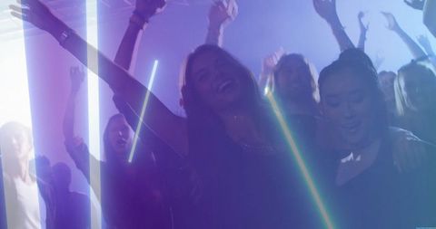 Vibrant Dancefloor Celebration at Nightclub with Neon LED Lights