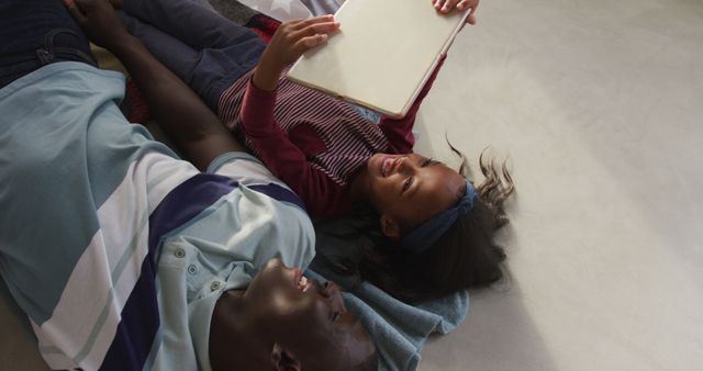 Father and Daughter Reading Book Together on Floor - Download Free Stock Images Pikwizard.com