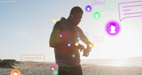 African American Man Syncing Smartwatch on Beach with Digital Icons